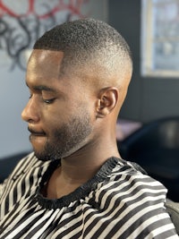 a black man sitting in a barber chair